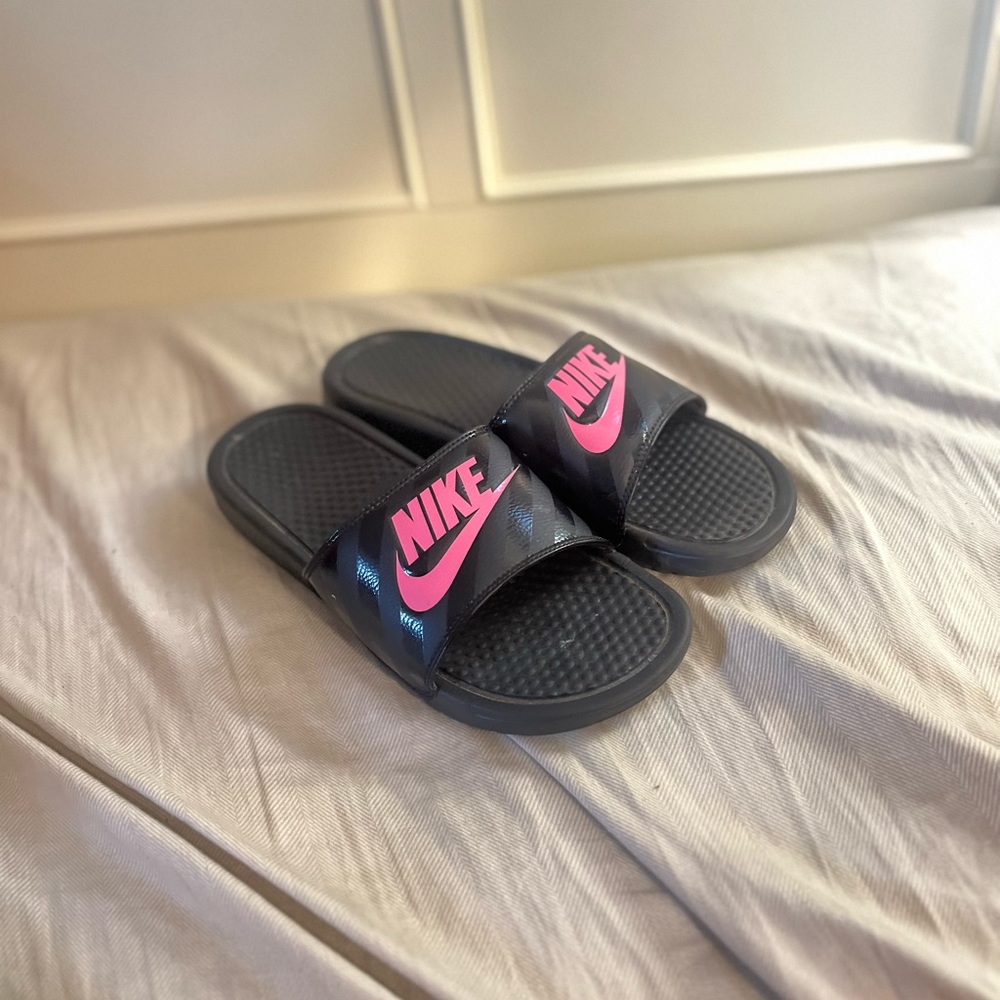pink and black Nike slides